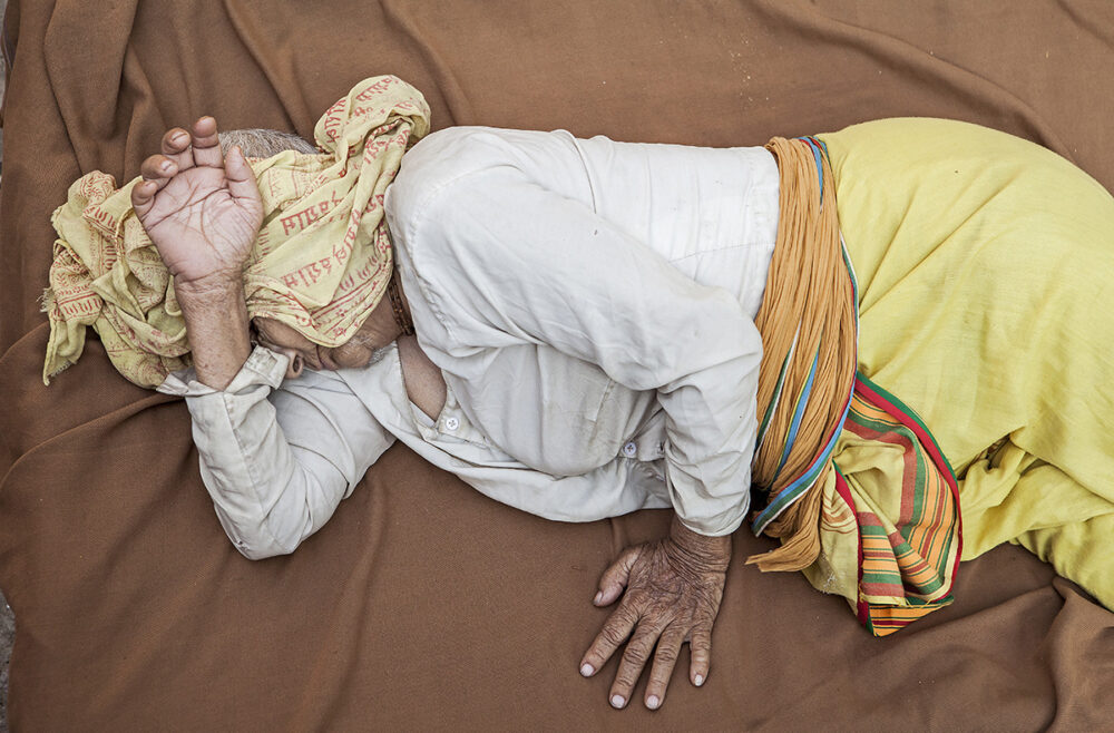 Photographic Social Vision - Widow sleeping in the street,homless, Vrindavan, Mathura district, India